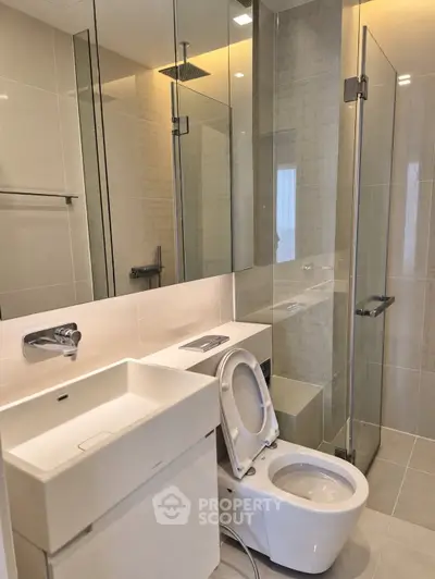 Modern bathroom with sleek fixtures and glass shower enclosure