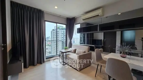 Modern living room with city view, featuring sleek furniture and large windows.