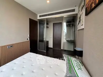 Modern bedroom with sleek design and natural light, featuring a comfortable bed and stylish decor.