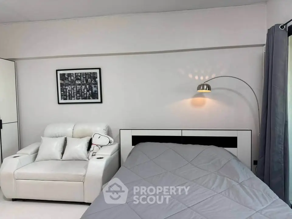 Modern bedroom with sleek white furniture and stylish decor