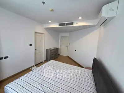 Spacious bedroom with modern air conditioning and stylish decor