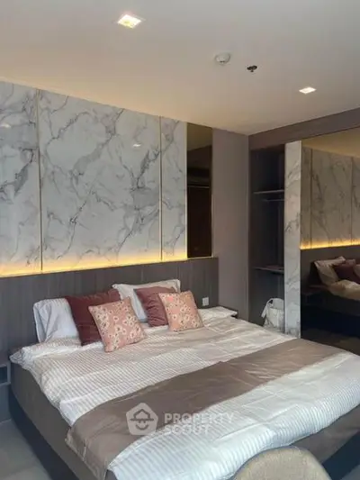 Luxurious bedroom with elegant marble accents and ambient lighting, perfect for modern living.