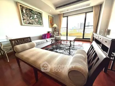 Luxurious living room with elegant furniture and city view balcony in upscale apartment.