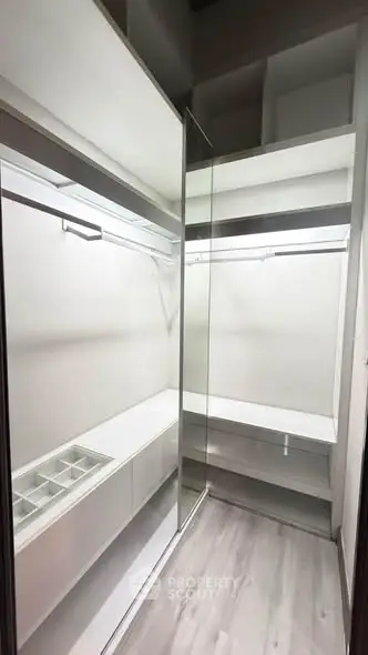 Spacious walk-in closet with modern shelving and ample storage space.