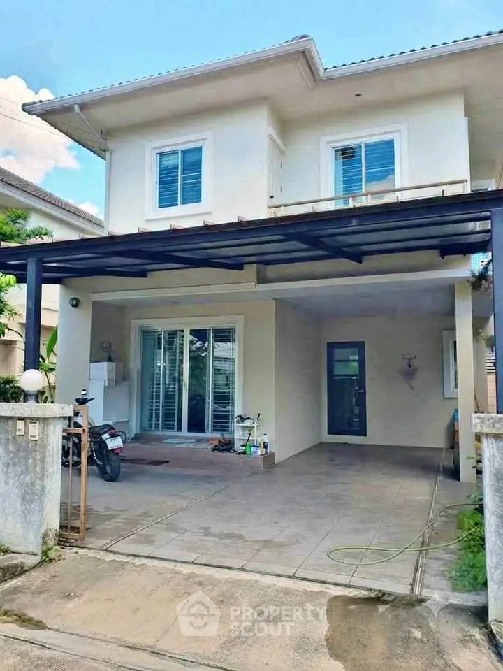 Charming two-story house with covered carport and modern exterior design in a serene neighborhood.