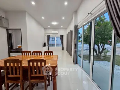 Spacious dining area with large windows and garden view in modern home