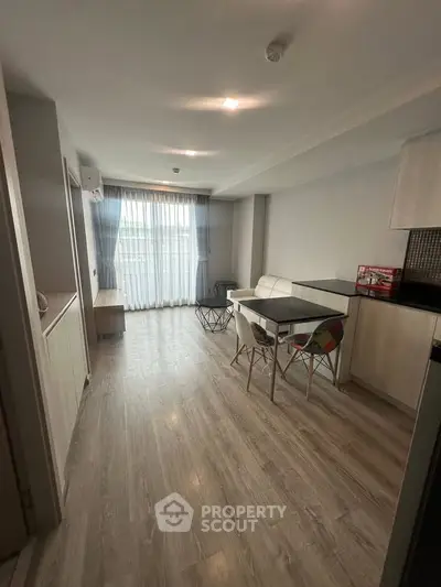 Modern living room with sleek furniture and large window for natural light