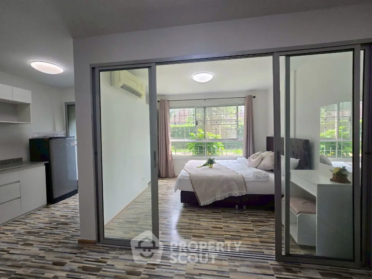 Modern studio apartment with glass partition and stylish flooring