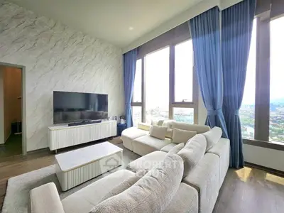 Luxurious living room with panoramic windows and elegant decor in a high-rise apartment.