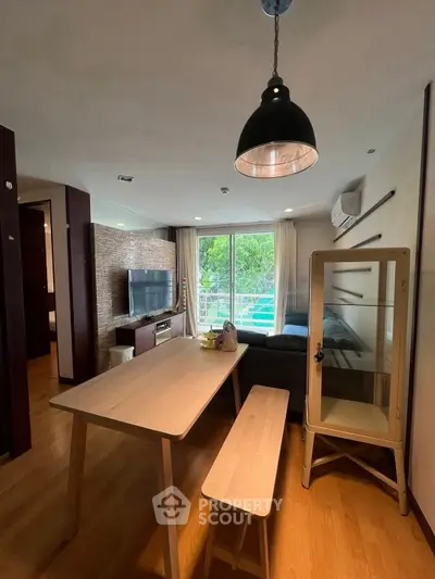 Modern living room with dining area and large window view.