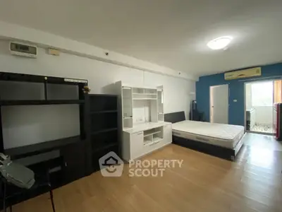 Spacious studio apartment with modern furnishings and balcony access