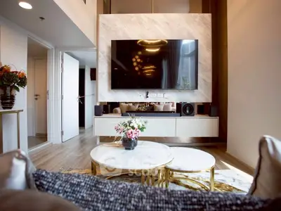 Luxurious modern living room with stylish decor and large wall-mounted TV