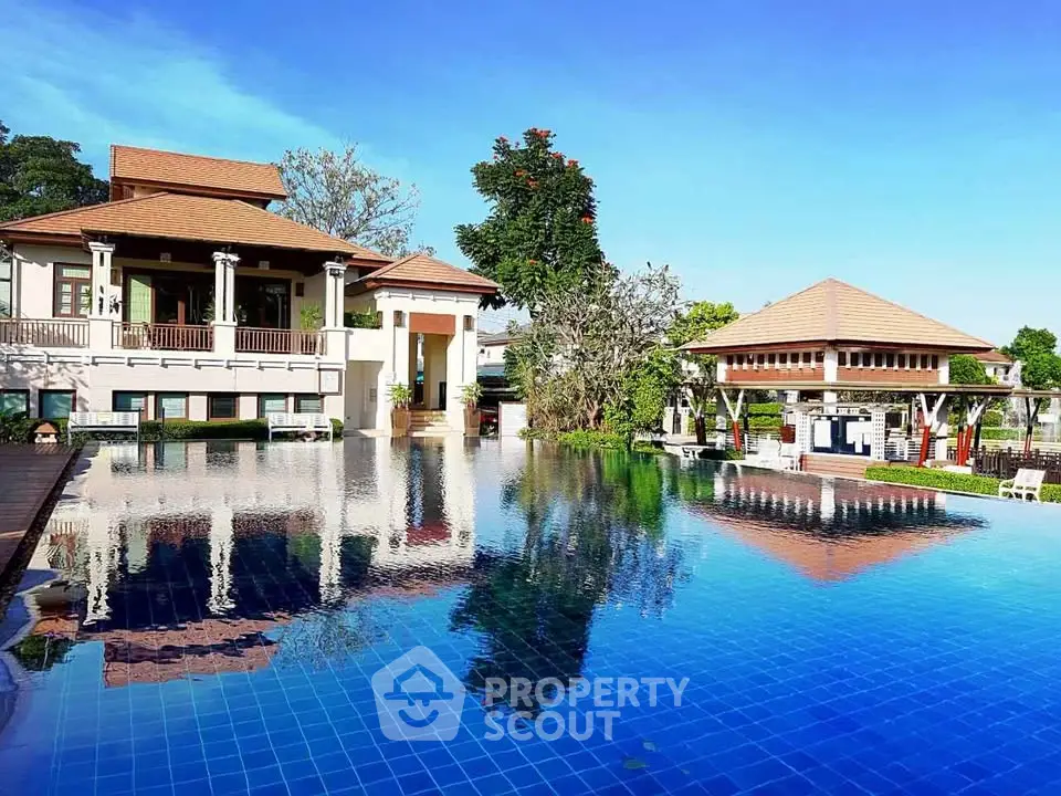 Luxurious villa with stunning pool and lush surroundings, perfect for relaxation and entertainment.