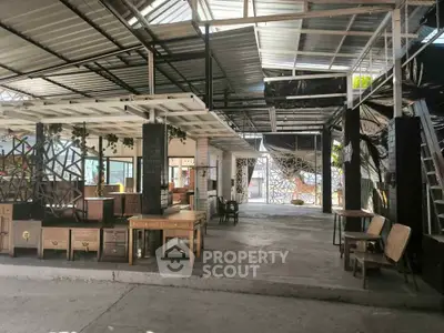 Spacious industrial-style open area with modern furniture and unique design elements.