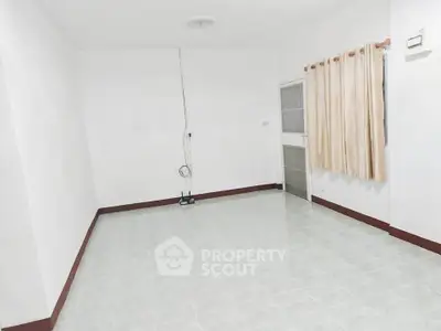 Spacious empty room with tiled floor and curtain, ideal for customization.