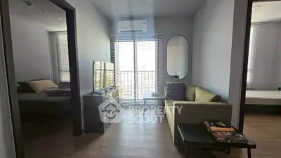 Modern living room with natural light, cozy sofa, and stylish decor in a contemporary apartment.