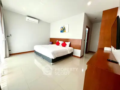 Spacious modern bedroom with sleek design and natural light