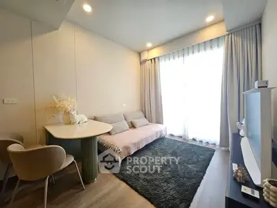 Modern living room with cozy sofa, elegant dining table, and large window for natural light.