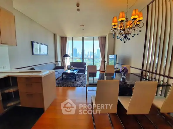 Spacious modern living room with city view, elegant dining area, and stylish chandelier in luxury apartment.
