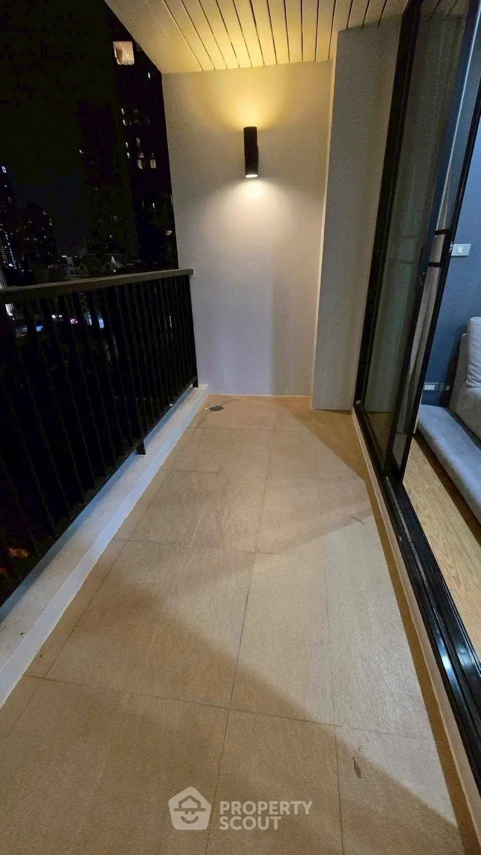 Spacious balcony with night city view and modern lighting