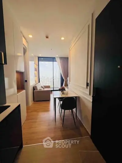 Modern apartment interior with open layout and stunning city view from balcony.