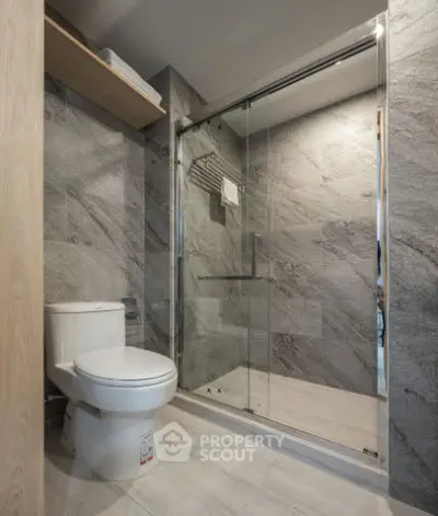 Modern bathroom with sleek shower and elegant gray tile design.