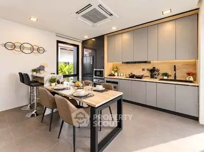 Modern kitchen with sleek cabinetry and dining area in stylish apartment