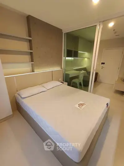 Modern bedroom with sleek design and integrated study area, featuring ambient lighting and minimalist decor.