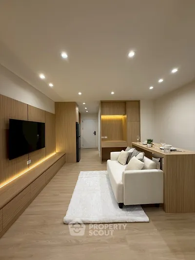 Modern living room with sleek wooden paneling and cozy white sofa