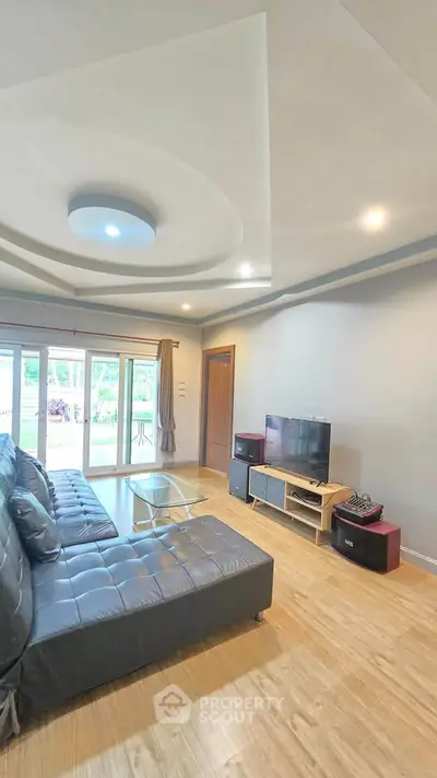 Spacious living room with modern decor and large windows for natural light.