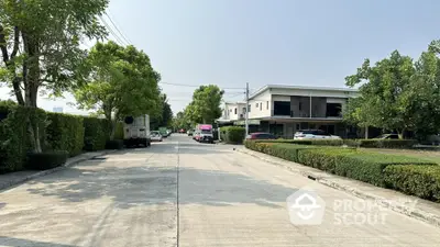 Modern residential street with contemporary houses and lush greenery