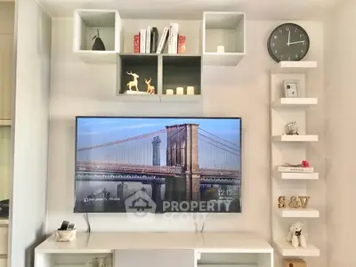 Modern living room with stylish shelving and wall-mounted TV