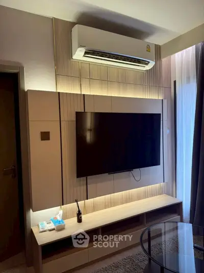 Modern living room with wall-mounted TV and air conditioning unit, featuring sleek wooden paneling and ambient lighting.