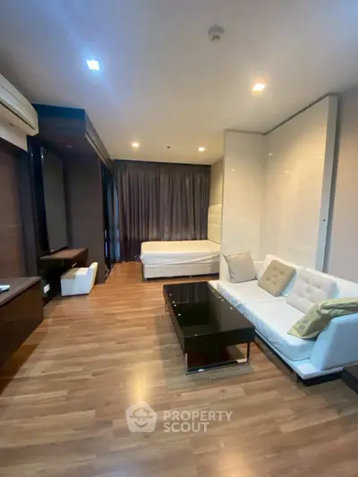 Modern studio apartment with stylish living area and cozy bedroom