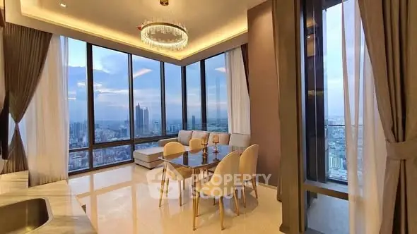 Luxurious corner unit living room with panoramic city views and elegant decor.