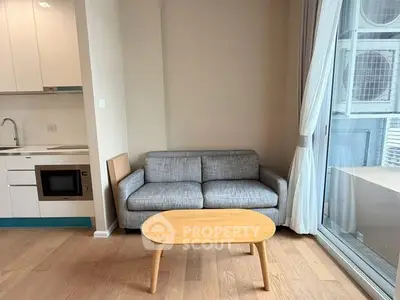 Modern living room with cozy sofa and kitchenette in a bright apartment