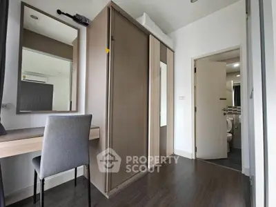 Modern bedroom with sleek wardrobe and study desk in stylish apartment