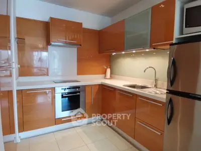 Modern kitchen with sleek wooden cabinets and stainless steel appliances