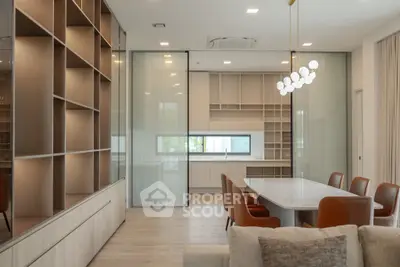 Modern open-plan living and dining area with sleek kitchen and stylish lighting