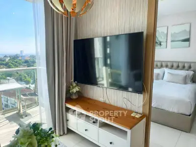 Modern bedroom with large TV and balcony view in luxury apartment
