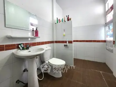 Spacious bathroom with modern fixtures and ample natural light.