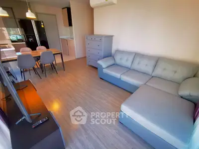 Modern living room with stylish furniture and open kitchen layout