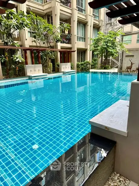Luxurious residential pool with modern design and lush greenery