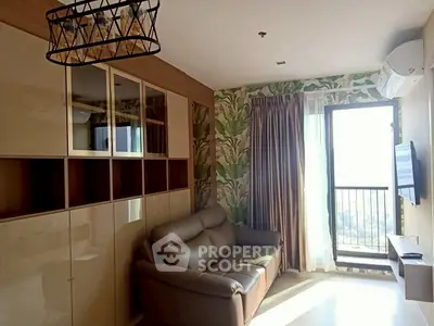 Stylish living room with modern sofa and balcony view, perfect for urban living.