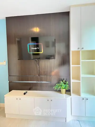 Modern living room with sleek TV setup and stylish cabinetry