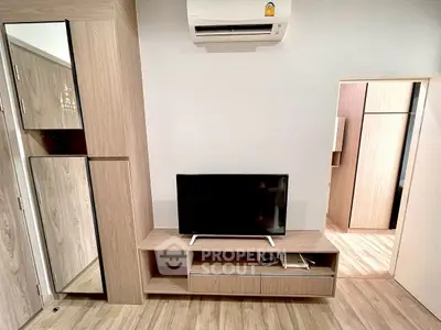 Modern living room with sleek wooden furniture and mounted TV