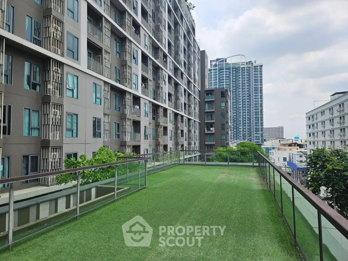 Modern apartment building with rooftop garden and city view