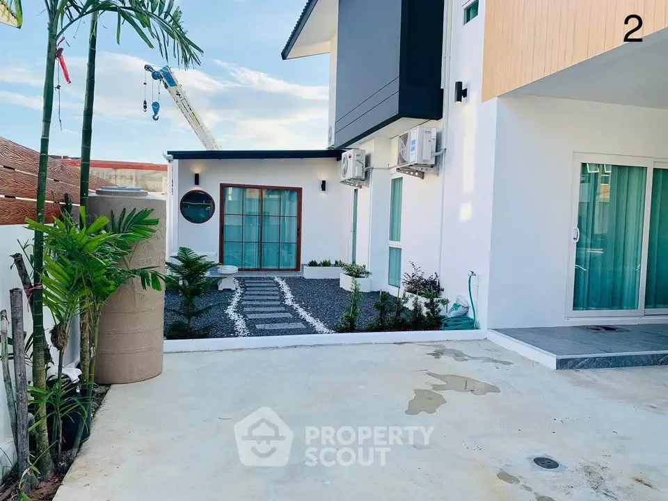 Modern exterior of a stylish home with landscaped garden and unique architectural design.