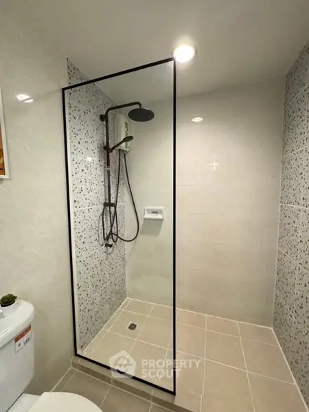 Modern bathroom with sleek shower design and neutral tiles