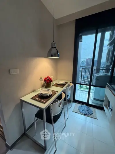 Modern kitchen with dining area and balcony view in a stylish apartment